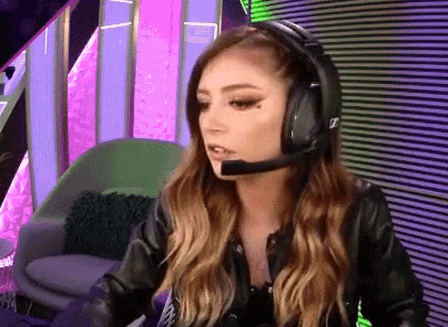 a woman wearing headphones and a leather jacket .
