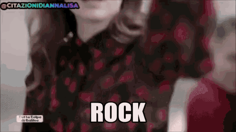 a woman in a red and black polka dot shirt with the word rock above her