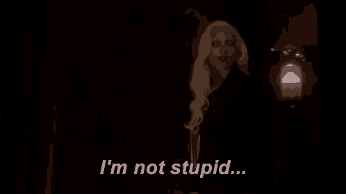 a woman is standing in a dark room and saying `` i 'm not stupid ... ''