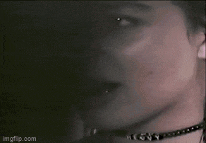 a close up of a woman wearing a choker on her neck .