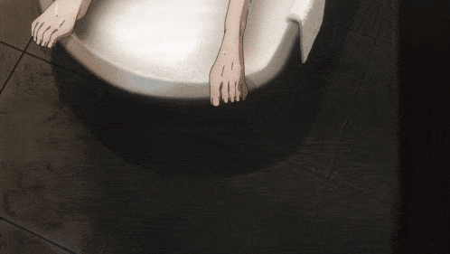 a person 's feet are shown on a toilet seat