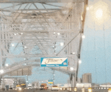a truck is driving under a bridge with a sign that says ' i 'm sorry ' on it