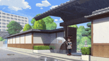 a girl is standing in front of a building with a bubble coming out of it