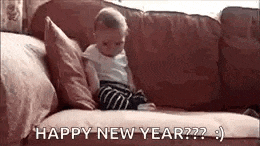 a baby is sitting on a couch with the words `` happy new year '' .