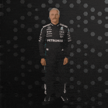 a man in a petronas outfit is clapping