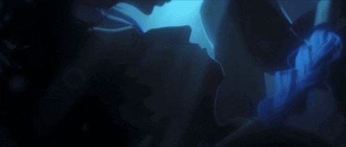 a couple kissing in a dark room with blue lights