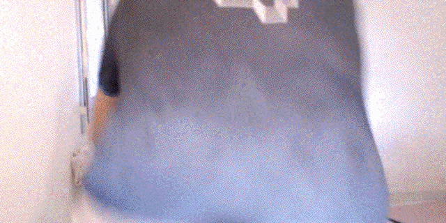 a person standing on a bed with a blanket on it