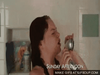 a woman is singing into a microphone while taking a shower on sunday afternoon