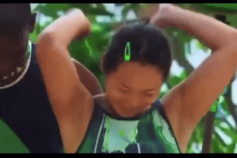 a woman with green hair clips in her hair is being held by a man