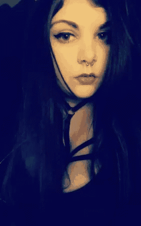 a woman with a nose ring and a choker around her neck