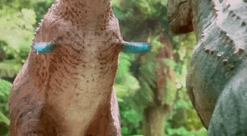 a statue of a dinosaur with a blue feather on its tail