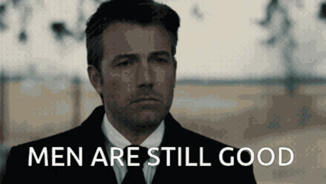 a man in a suit and tie with the words men are still good