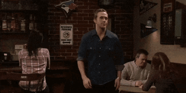 a group of people are dancing in a bar with a sign that says reserved parking