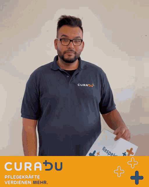 a man in a curadu shirt holds a piece of paper in his hand