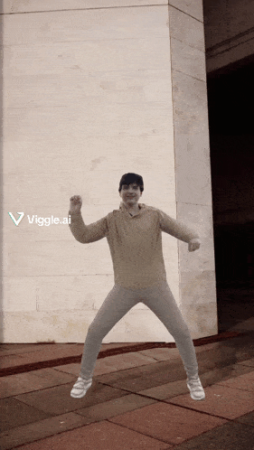 a person is dancing in front of a wall with the words viggle.ai visible