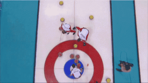 a group of people are playing curling and one of them has the word russia on their shirt
