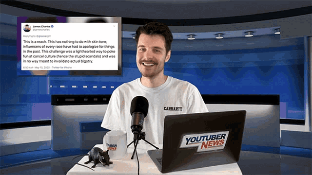 a man is sitting in front of a laptop with youtuber news written on it