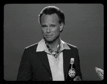 a man holds a bottle of nuka cola