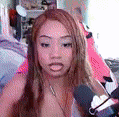 a woman is sitting in front of a microphone in a bedroom .