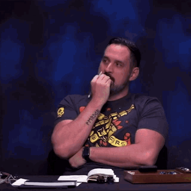 a man wearing a t-shirt that says shoot firs is laughing