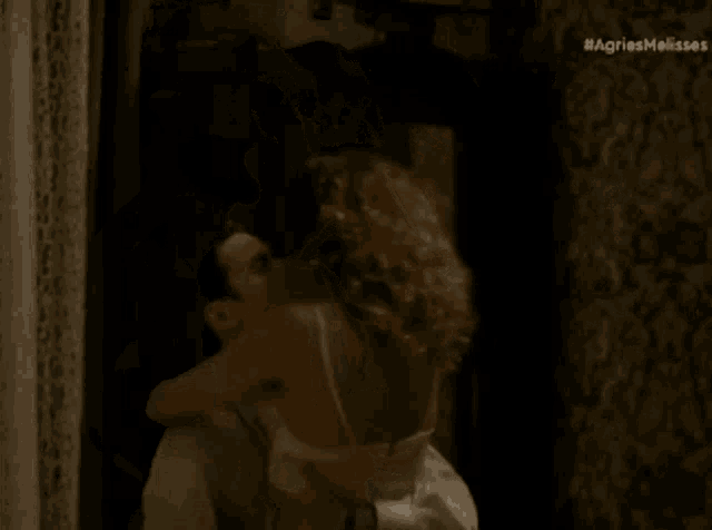 a woman is laying on a man 's lap with the hashtag agriesmelisses visible in the corner