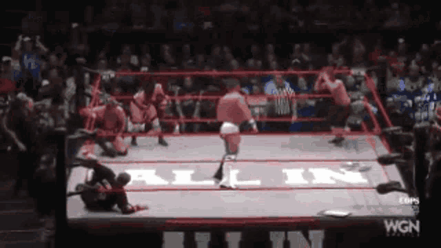 wrestlers in a ring with the word all in on the mat