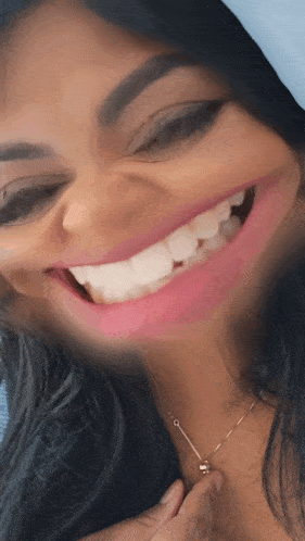 a close up of a woman 's face with a big smile on it