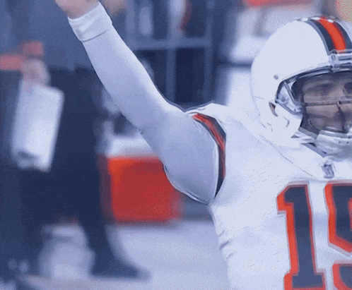 a football player wearing a white jersey with the number 19