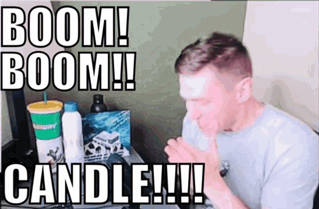 a man sitting in front of a computer with the words boom boom candle written on it