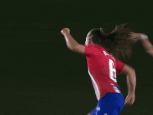 a blurred image of a soccer player wearing a number 6 jersey