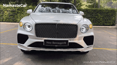 a white bentley is parked in a parking lot with a youtube link
