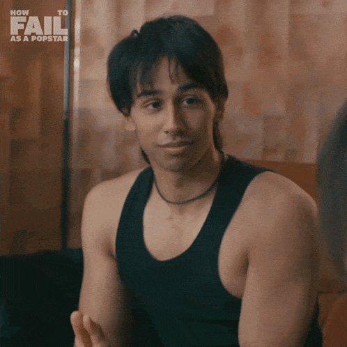 a man in a black tank top with the words how to fail as a popstar