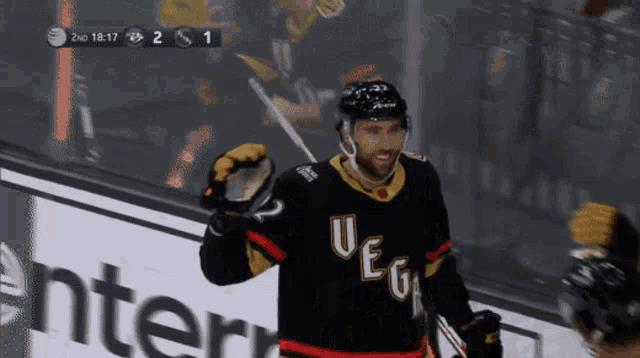 a hockey player wearing a jersey that says " vegas " on it