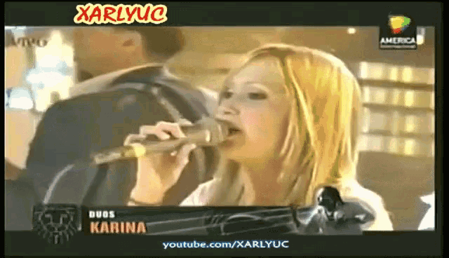 a woman singing into a microphone with the name karina on the bottom of the screen