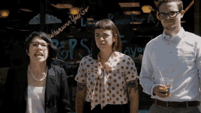 three people standing in front of a sign that says gps on it