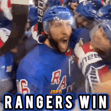 a hockey player is surrounded by his teammates and says " rangers win "