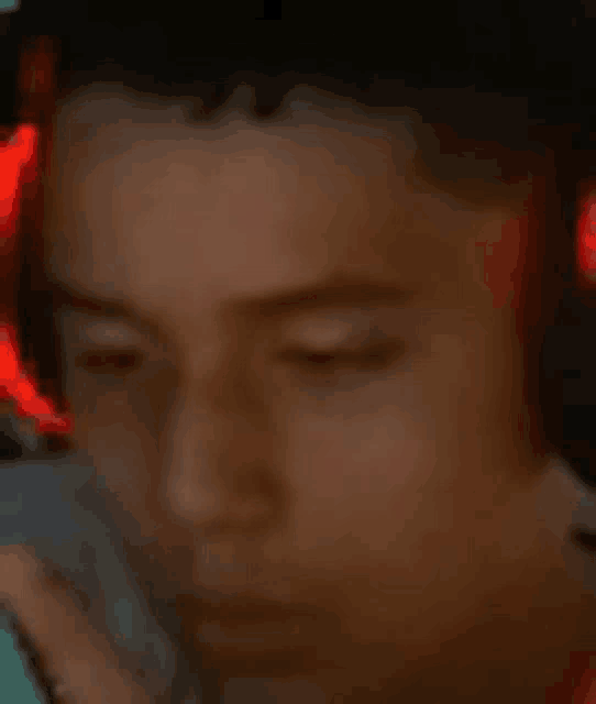 a close up of a person wearing headphones with red lights on their ears .