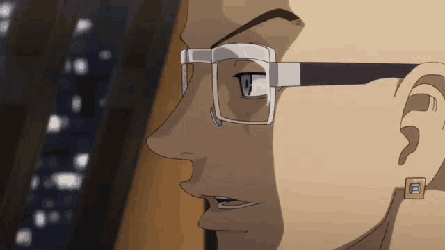 a close up of a man 's face with glasses
