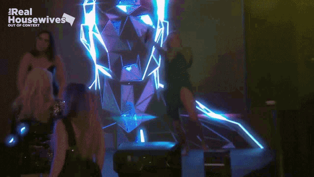 a group of women dancing in front of a screen that says real housewives out of context