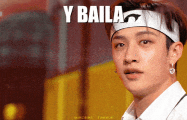 a young man wearing a headband with the word y baila on it