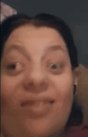 a close up of a woman making a funny face with her eyes closed .