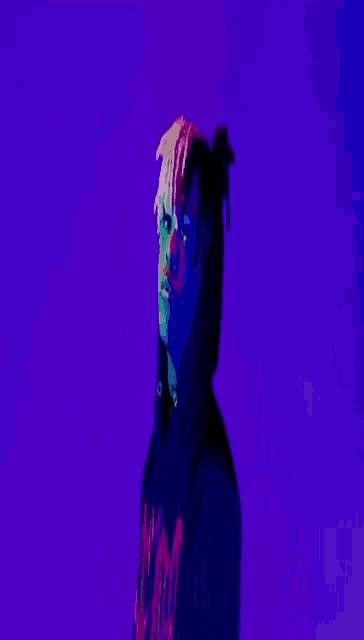 a person in a black shirt with the word supreme on the back is laying on a purple background