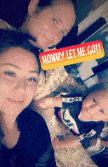 two women and a child are posing for a picture with a sign that says mommy let he go