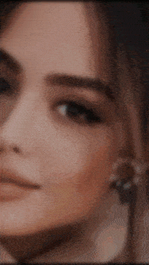 a close up of a woman 's face with a blurry background