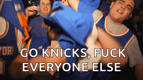 a group of men are cheering for the new york knicks basketball team