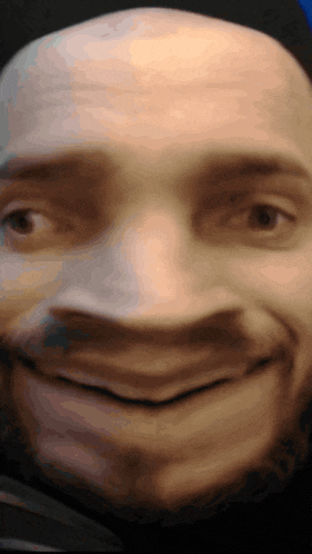 a close up of a man 's face with a smile