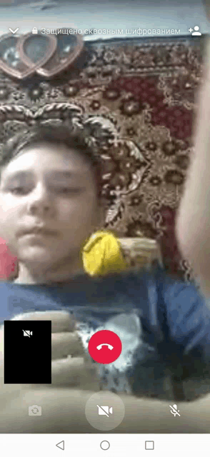 a phone screen shows a man talking to another man in a video call