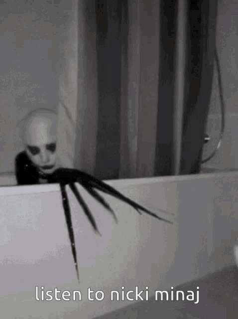 a black and white photo of a monster with the words listen to nicki minaj below it