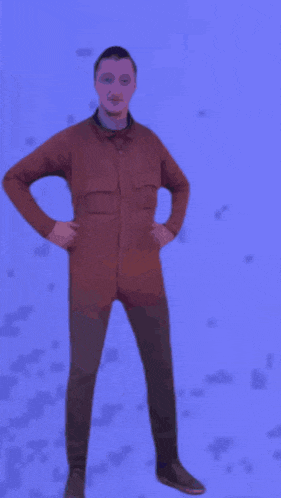 a man in a red jacket is dancing in front of a purple background