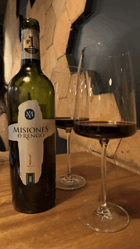 a bottle of misiones d rengo wine sits next to a glass